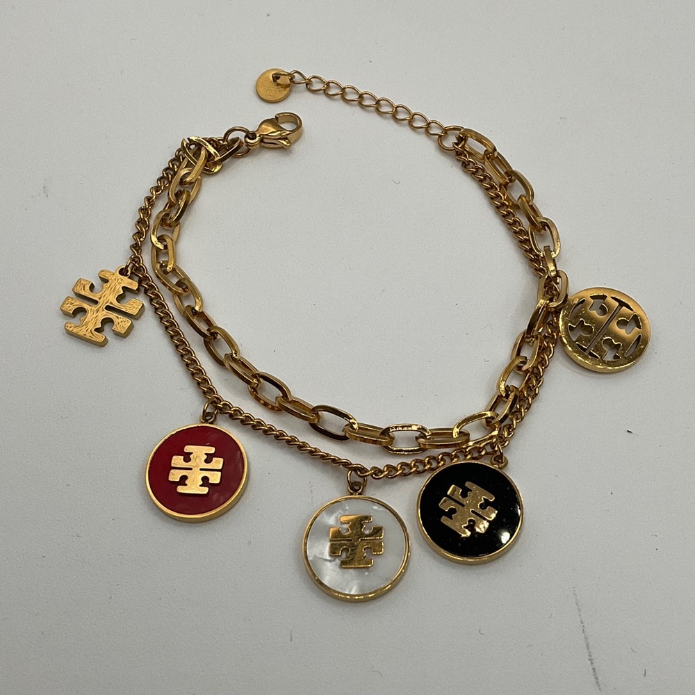 Tory Burch Gold Bracelet with Red, White, and Black Charms